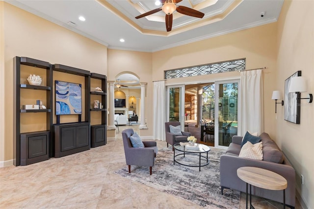 sitting room featuring ceiling fan, ornamental molding, and a tray ceiling