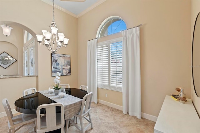 dining area with ornamental molding and a notable chandelier