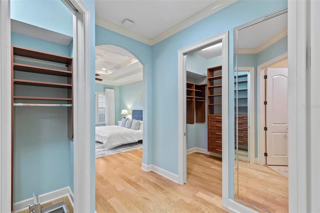 hall featuring light wood-type flooring and ornamental molding