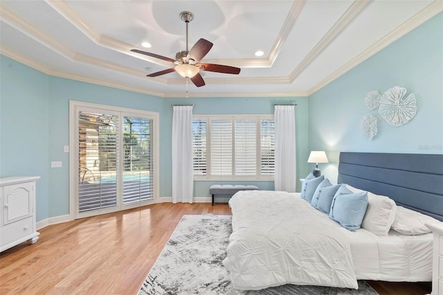 bedroom with access to outside, ornamental molding, a raised ceiling, and ceiling fan