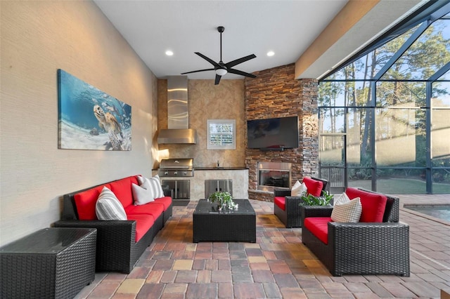 interior space with ceiling fan and an outdoor stone fireplace