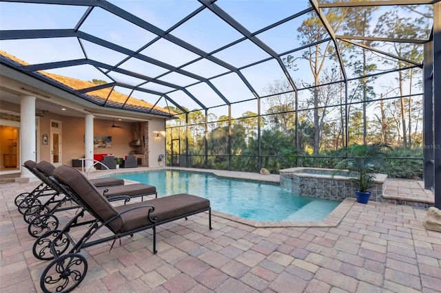 view of swimming pool with an in ground hot tub, a lanai, ceiling fan, and a patio area