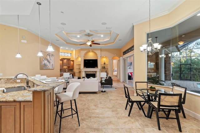 dining area with crown molding, ceiling fan with notable chandelier, coffered ceiling, and sink