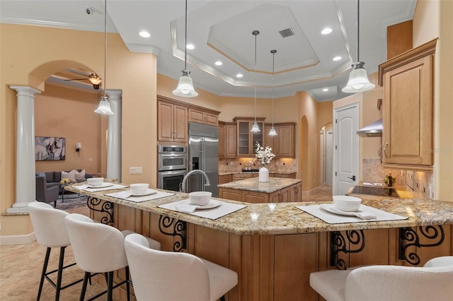 kitchen featuring appliances with stainless steel finishes, crown molding, backsplash, and decorative light fixtures