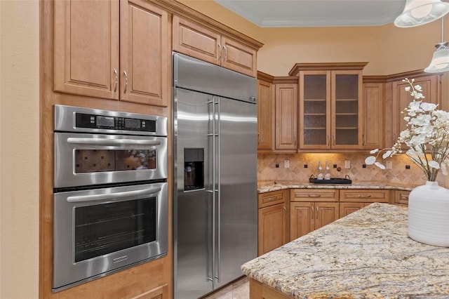 kitchen with appliances with stainless steel finishes, tasteful backsplash, ornamental molding, pendant lighting, and light stone counters