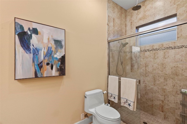 bathroom featuring toilet and an enclosed shower