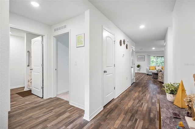 hallway with dark hardwood / wood-style floors