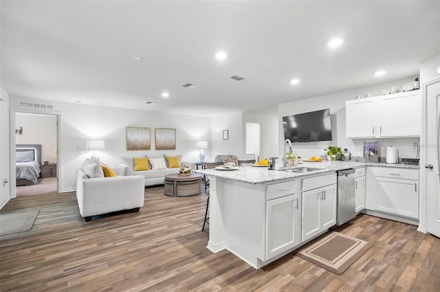 kitchen with white cabinetry, dishwasher, wood-type flooring, and sink