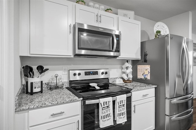 kitchen featuring light stone counters, white cabinets, and appliances with stainless steel finishes