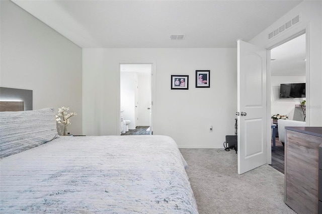 carpeted bedroom featuring connected bathroom