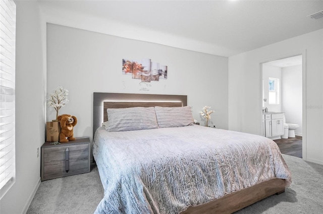 carpeted bedroom with ensuite bathroom