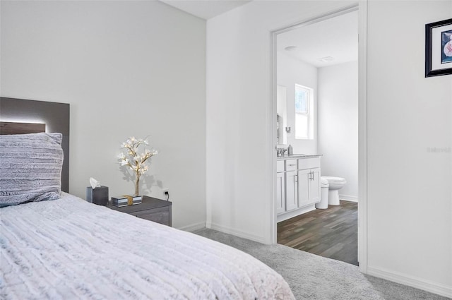 carpeted bedroom featuring ensuite bath