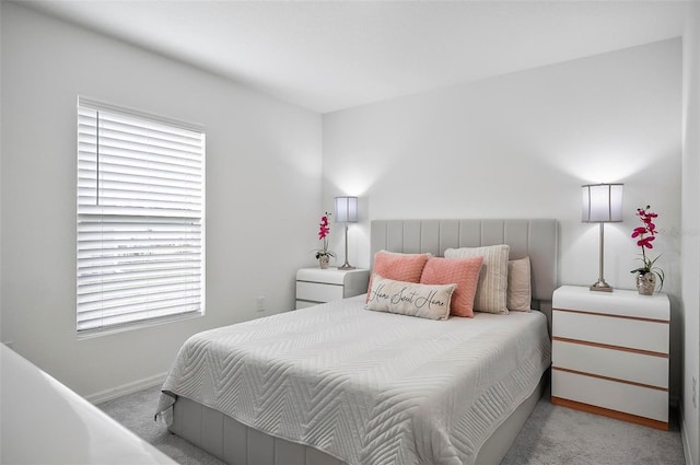 bedroom featuring light carpet