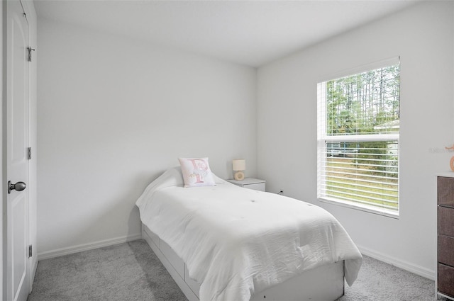 bedroom featuring light carpet