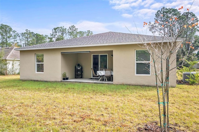 rear view of property with a patio area and a yard