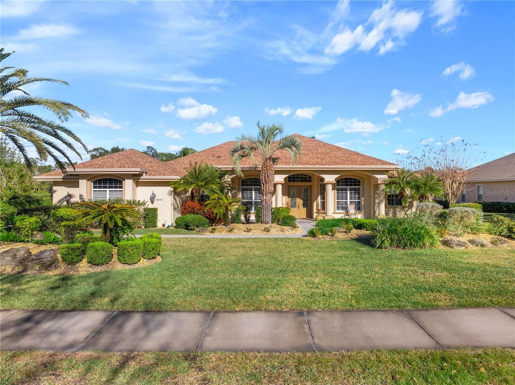 mediterranean / spanish house featuring a front lawn