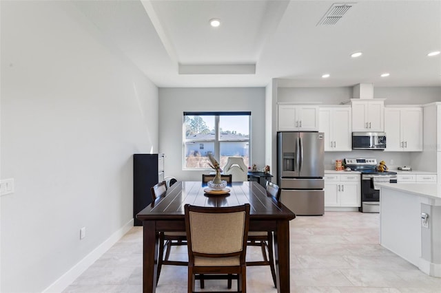 dining room with a tray ceiling