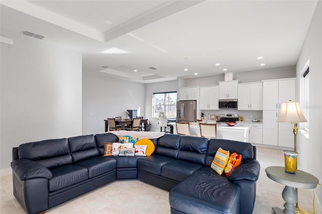 living room with a tray ceiling