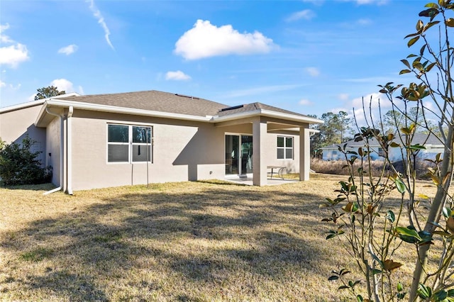 rear view of property with a patio area and a lawn