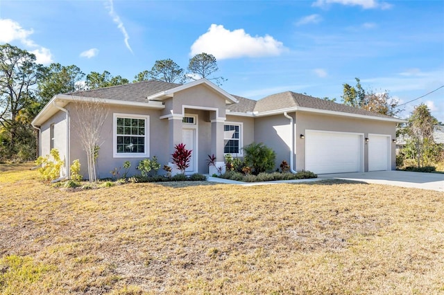 ranch-style home featuring a garage and a front yard