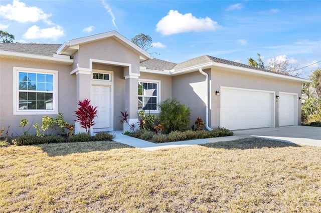 ranch-style home with a garage and a front yard