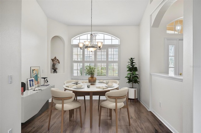 dining room with an inviting chandelier and dark hardwood / wood-style floors