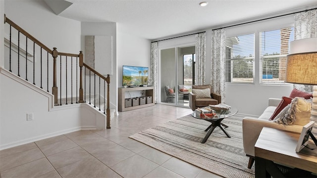 interior space featuring a textured ceiling and light tile patterned floors