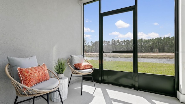 sunroom with a water view and plenty of natural light