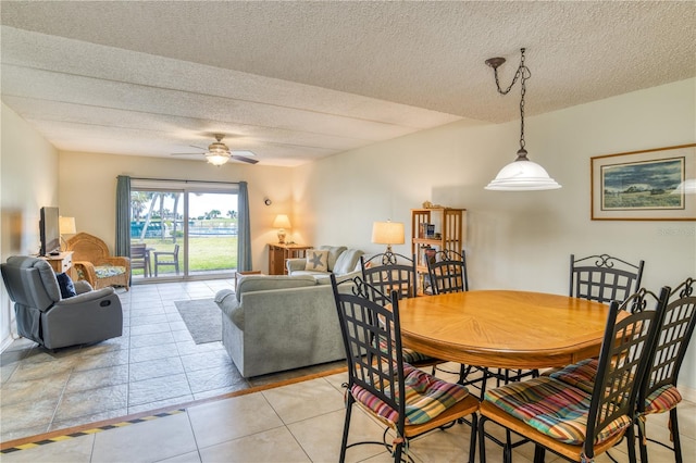 dining room featuring ceiling fan, a textured ceiling, and light tile patterned floors