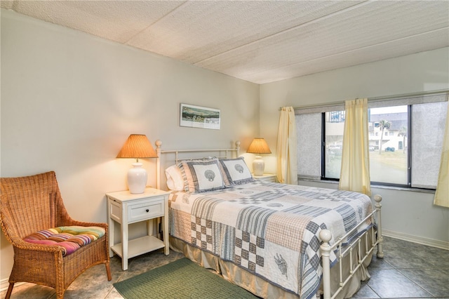 tiled bedroom featuring a textured ceiling