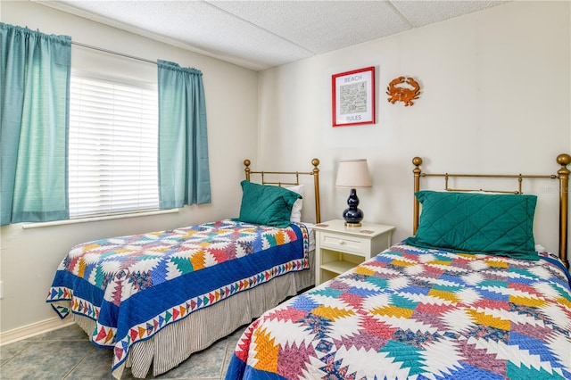 tiled bedroom featuring a textured ceiling