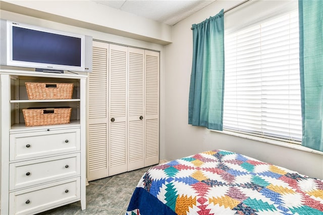 tiled bedroom featuring a closet