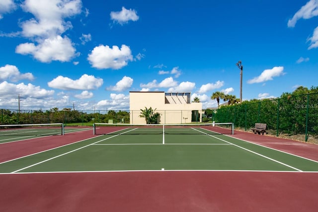 view of tennis court with basketball hoop