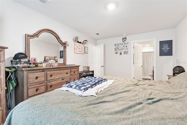 bedroom with visible vents and ensuite bathroom