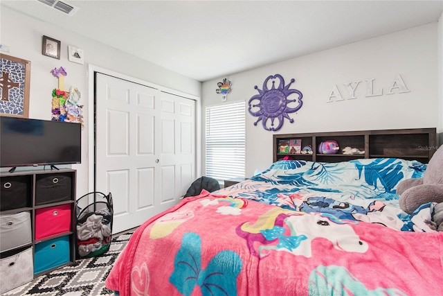 bedroom featuring a closet and visible vents