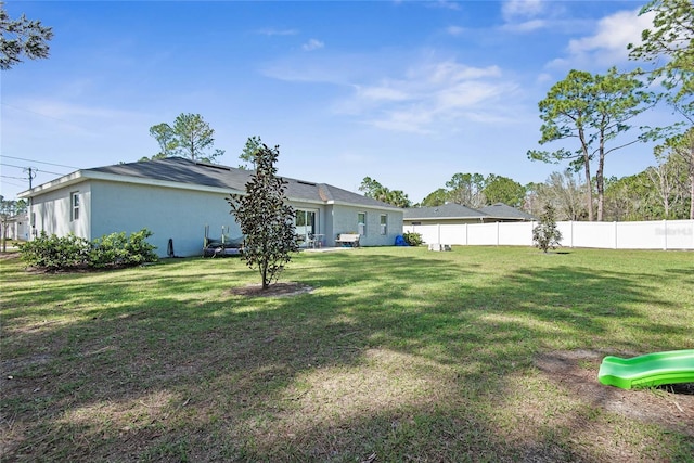 view of yard with a fenced backyard and a playground