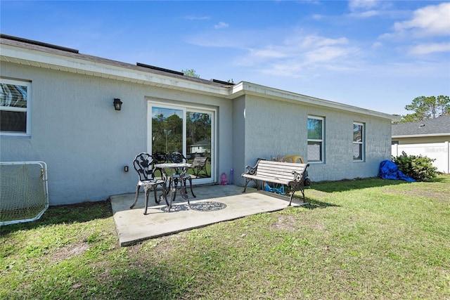 rear view of property with a patio area, fence, and a lawn