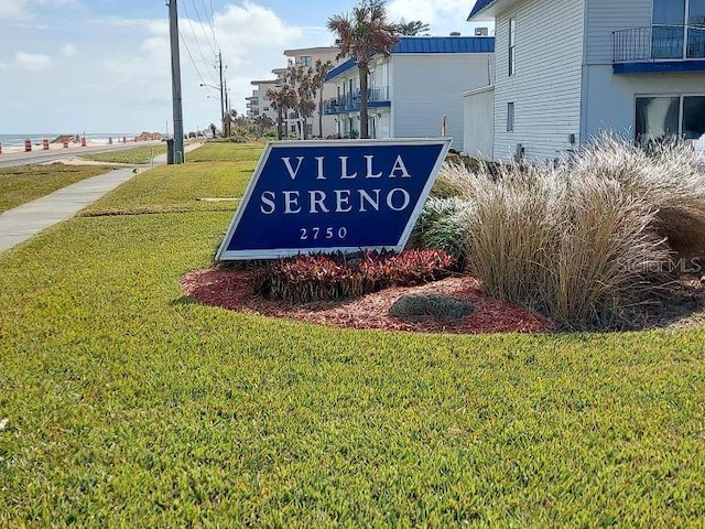 community / neighborhood sign featuring a yard