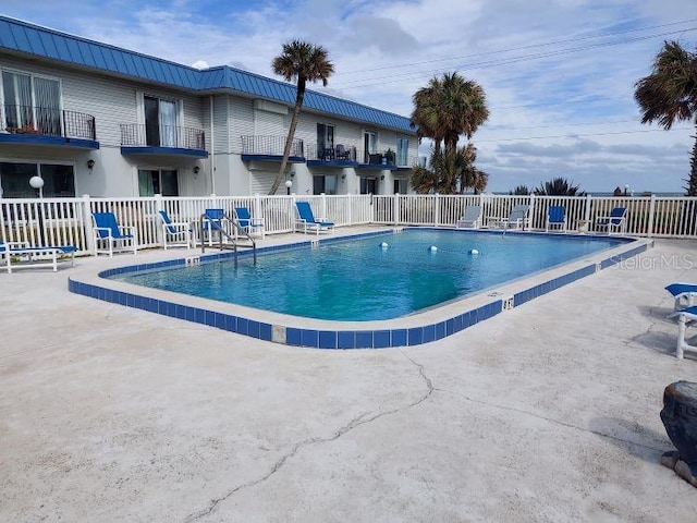 view of swimming pool featuring a patio