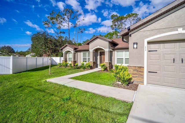 view of front facade featuring a garage and a front lawn