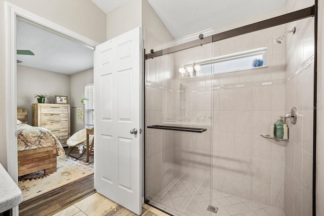 bathroom with tile patterned flooring and a shower with shower door