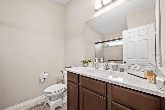 bathroom featuring vanity, toilet, and walk in shower