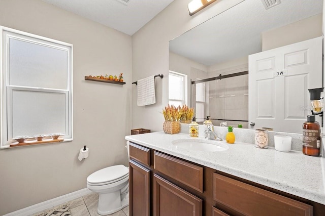 bathroom featuring vanity, toilet, tile patterned floors, and a shower with shower door