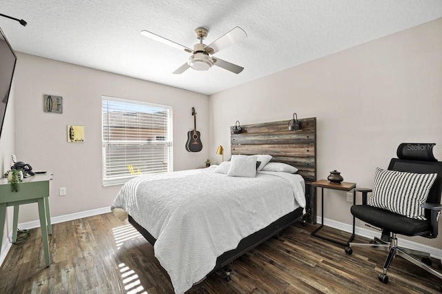 bedroom featuring a textured ceiling, dark wood-type flooring, and ceiling fan