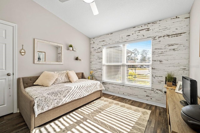 bedroom with ceiling fan, dark hardwood / wood-style floors, and vaulted ceiling