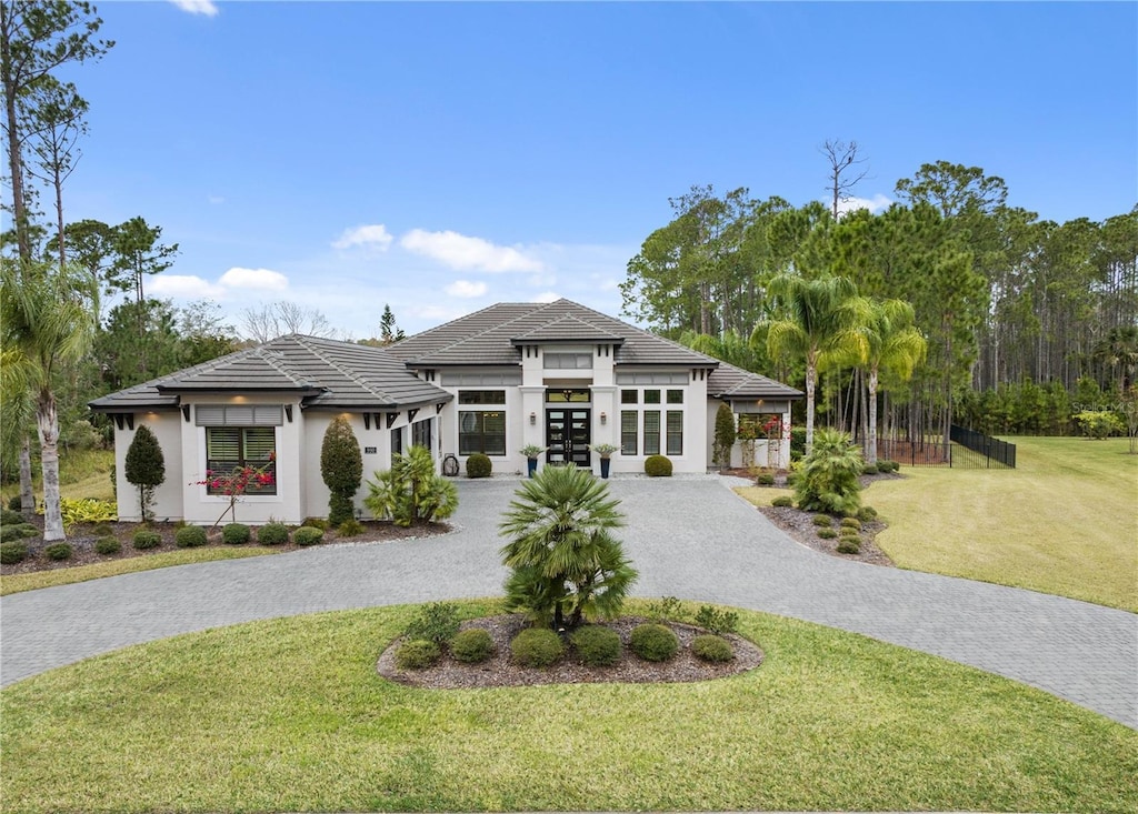 prairie-style house with a front yard and french doors