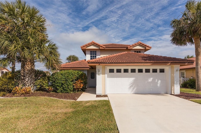 mediterranean / spanish house with a garage and a front lawn