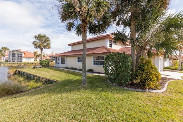 view of side of property with a lawn