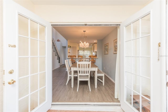 dining area with an inviting chandelier and hardwood / wood-style floors