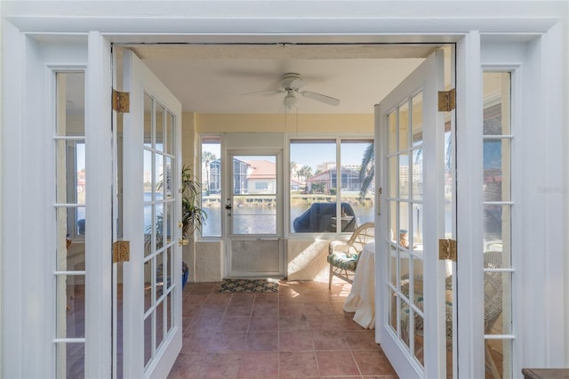 unfurnished sunroom featuring french doors and ceiling fan